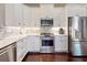 Modern kitchen with stainless steel appliances and stylish backsplash at 2656 Old Smyrna Trl, New Smyrna Beach, FL 32168