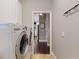 Functional laundry room with modern washer and dryer set and storage, perfect for convenience at 2656 Old Smyrna Trl, New Smyrna Beach, FL 32168