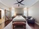 Elegant main bedroom featuring hardwood floors, natural light, and a rustic sliding barn door at 2656 Old Smyrna Trl, New Smyrna Beach, FL 32168