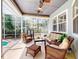 Screened-in patio with ceiling fans, comfortable wicker furniture, and outdoor views at 2656 Old Smyrna Trl, New Smyrna Beach, FL 32168