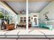 Covered back patio featuring cozy seating and a view of the screened-in lanai at 2656 Old Smyrna Trl, New Smyrna Beach, FL 32168