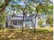 Backyard view of house featuring a screened in pool and lush greenery at 2656 Old Smyrna Trl, New Smyrna Beach, FL 32168