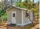 Cozy outdoor shed with painted wood siding, providing extra storage space at 2656 Old Smyrna Trl, New Smyrna Beach, FL 32168