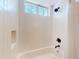 Bathroom shower featuring white tile and transom window at 2656 Old Smyrna Trl, New Smyrna Beach, FL 32168