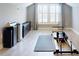 Bright studio space featuring large windows, gray floors, and pilates workout equipment at 2656 Old Smyrna Trl, New Smyrna Beach, FL 32168