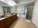 Bathroom featuring double vanity, soaking tub, separate shower, and elegant finishes at 2801 S Ridgewood Ave # 512, South Daytona, FL 32119