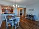 Dining room with wood floors, open to kitchen with granite counters and stainless appliances at 2801 S Ridgewood Ave # 512, South Daytona, FL 32119