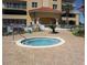 Community hot tub situated on a brick-paved area, with a lush landscape setting at 2801 S Ridgewood Ave # 512, South Daytona, FL 32119