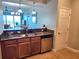 Kitchen bar featuring granite countertops, stainless steel sink and appliances, and modern lighting at 2801 S Ridgewood Ave # 512, South Daytona, FL 32119