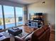 Bright living room with hardwood floors, leather furniture and balcony access offering water views at 2801 S Ridgewood Ave # 512, South Daytona, FL 32119