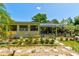 Spacious backyard with a variety of plants, stone pathways and a covered back patio at 2914 Sabal Palm Dr, Edgewater, FL 32141