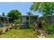 Cozy backyard with a covered patio, surrounded by beautiful plants and a wooden fence at 2914 Sabal Palm Dr, Edgewater, FL 32141