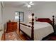 Bedroom featuring hardwood flooring, queen bed with dark wood frame, dresser and side table at 2914 Sabal Palm Dr, Edgewater, FL 32141