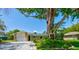 Charming single-story home with mature trees, stone accents, and an attached single car garage at 2914 Sabal Palm Dr, Edgewater, FL 32141