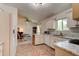 Bright kitchen with tile floors, white cabinets, and a cozy breakfast nook at 2914 Sabal Palm Dr, Edgewater, FL 32141