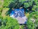 Aerial view of house surrounded by mature trees, featuring a well-manicured yard at 3013 Lime Tree Dr, Edgewater, FL 32141