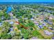 Aerial view of a residential property with mature trees and proximity to a lake at 3013 Lime Tree Dr, Edgewater, FL 32141