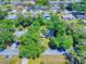 Aerial view of a residential property with lush trees and a view of the surrounding neighborhood at 3013 Lime Tree Dr, Edgewater, FL 32141