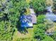 Overhead shot of a single-story home, with large trees providing shade and a well-kept lawn at 3013 Lime Tree Dr, Edgewater, FL 32141
