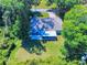 Aerial view of a single-story house with a screened-in porch and patio furniture at 3013 Lime Tree Dr, Edgewater, FL 32141