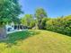 Spacious backyard with well-maintained lawn and trees, ideal for entertainment and enjoying the outdoors at 3013 Lime Tree Dr, Edgewater, FL 32141