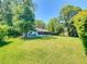 Large backyard showcasing a screened porch and ample green space, offering privacy and room to roam at 3013 Lime Tree Dr, Edgewater, FL 32141