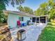 Backyard patio featuring a grill, seating, and access to a screened-in porch for outdoor enjoyment at 3013 Lime Tree Dr, Edgewater, FL 32141