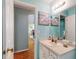 Bright bathroom features a white vanity, beachy art and a large mirror at 3013 Lime Tree Dr, Edgewater, FL 32141