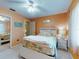 Bright bedroom featuring a white bed frame, floral comforter, and a mirrored closet at 3013 Lime Tree Dr, Edgewater, FL 32141