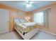 Comfortable bedroom featuring a white bed frame, floral comforter, and ample natural light at 3013 Lime Tree Dr, Edgewater, FL 32141