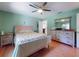 Bedroom featuring a ceiling fan, hardwood floors, and decorative furniture at 3013 Lime Tree Dr, Edgewater, FL 32141