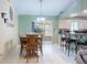 Light and airy dining room with tiled floors, a wooden table and chairs, and a sliding glass door at 3013 Lime Tree Dr, Edgewater, FL 32141