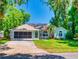Inviting single-story home with a well-kept lawn, mature palm and native plants and a screened garage at 3013 Lime Tree Dr, Edgewater, FL 32141