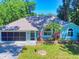 Inviting single-story home featuring a well-kept lawn, palm tree, and charming architectural details at 3013 Lime Tree Dr, Edgewater, FL 32141