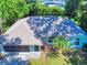 Charming single-story home with palm trees, arched windows, and a well-maintained lawn at 3013 Lime Tree Dr, Edgewater, FL 32141