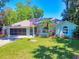Charming single-story home with well-manicured lawn, mature trees, and an attached two-car garage at 3013 Lime Tree Dr, Edgewater, FL 32141