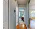 Hallway leading to a room with a desk and chair, and a view of the living room beyond at 3013 Lime Tree Dr, Edgewater, FL 32141