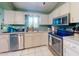 Kitchen features stainless steel appliances and granite countertops with white tile flooring at 3013 Lime Tree Dr, Edgewater, FL 32141