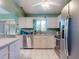 Open kitchen with stainless steel appliances, granite countertops and view into the living space at 3013 Lime Tree Dr, Edgewater, FL 32141