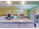 Kitchen bar with view to dining room and sliding glass doors to the patio at 3013 Lime Tree Dr, Edgewater, FL 32141