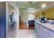 View from the kitchen into the living space with wood flooring and arched window at 3013 Lime Tree Dr, Edgewater, FL 32141