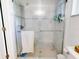 Bright bathroom featuring a tile shower with glass doors, a shower head, and chrome hardware at 3013 Lime Tree Dr, Edgewater, FL 32141