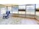 Inviting sun room with lots of natural light, tile flooring, and a comfortable rocking chair at 3013 Lime Tree Dr, Edgewater, FL 32141