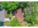 Aerial view of a single-story home with well-maintained lawn and mature trees and long driveway at 3016 Mango Tree Dr, Edgewater, FL 32141