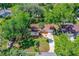 Beautiful aerial view of a home with a long driveway and large, shady trees at 3016 Mango Tree Dr, Edgewater, FL 32141