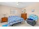 Cozy bedroom featuring matching night stand and dresser, a ceiling fan, and comfortable chair at 3016 Mango Tree Dr, Edgewater, FL 32141