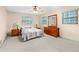 Cozy bedroom features neutral carpet, ceiling fan, and two windows that provide natural light at 3016 Mango Tree Dr, Edgewater, FL 32141