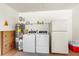 Garage with washer, dryer, and refrigerator with bonus storage space for bins and water heater at 3016 Mango Tree Dr, Edgewater, FL 32141