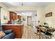 Eat in kitchen includes wood cabinets, wood look floors, and white appliances at 3016 Mango Tree Dr, Edgewater, FL 32141