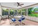 Enclosed lanai with plenty of seating, a ceiling fan, and view of back yard at 3016 Mango Tree Dr, Edgewater, FL 32141